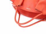 orange leather handbag with shoulder strap and zipper closure
