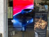 a sign in the window of a store with a picture on it