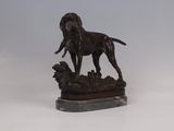 statue of a dog standing on a rock on a white background