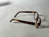 a pair of glasses sitting on a white surface