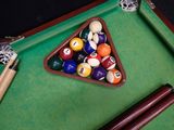 a pool table with balls and cues on it