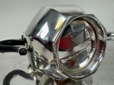 a close up of a motorcycle with a chrome headlight