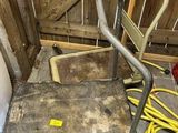 a dolly that is sitting on the floor next to a hose