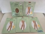 four pairs of footless stockings sitting on top of a bed