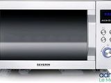 a silver microwave oven with a digital display on the front