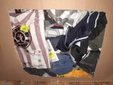 a cardboard box filled with clothes and other items