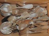 a lot of silver spoons and spoons in a box