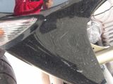 a close up of a motorcycle with a person in the background