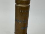 a small brass object with a blue writing on it