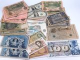 many different types of currency are laid out on a white surface