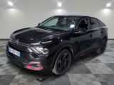 la voiture noire est garée sur un sol en damier dans le garage