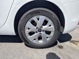 a close up of a tire on a white car