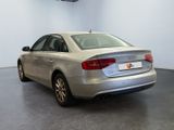the back of a silver car is parked in a large room