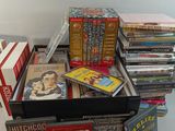 a lot of dvds in a box on a table