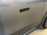 a close up of a car door with a sticker on it