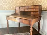 a wooden desk with a drawer on top of it