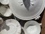 a cardboard box full of dishes and cups and saucers