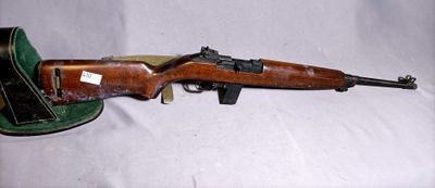 rifle and hat sitting on a white surface