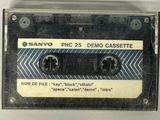 an old cassette with a label on it sitting on top of a table