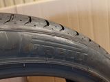 a close up of a tire on a wooden floor next to a wall