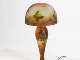 a lamp that is sitting on a shelf next to a wall