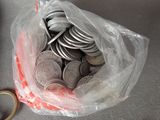 a bag of coins and a pair of scissors on a table