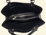 a black purse that is hanging on a wall