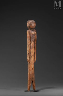 a wooden statue of a man with a hat on his head