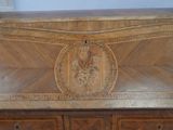 a wooden chest with carvings on the top of it