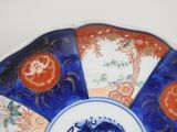 a blue and white plate with a blue and red design on it