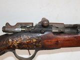 an old rifle with a wooden barrel and a metal handle