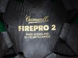 the back of a black firepro 2 jacket with a gold logo on it