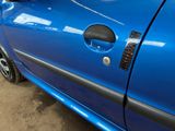 a close up of a car door handle with a sticker on it