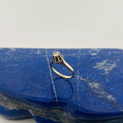 a close up of a silver ring on a blue stone