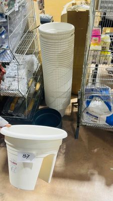 a man that is standing next to a bucket of water