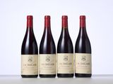 three bottles of red wine sitting on top of a table