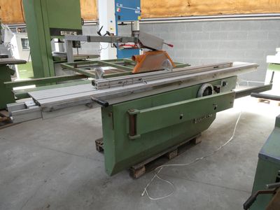 a machine that is cutting a piece of wood in a factory