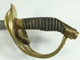 a close up of a sword on a white surface