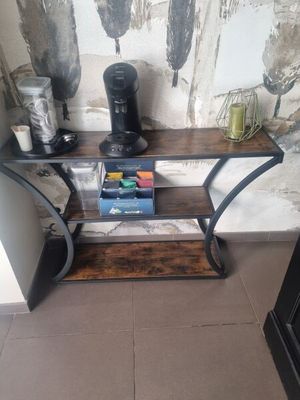 une petite table sur laquelle est posée une cafetière