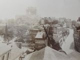 an old photo of a view of a city from the top of a building