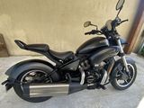 a black motorcycle parked in front of a building