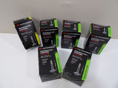 six black and green packagings for a new product on a white surface