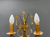 a gold chandelier with three lights attached to it