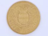 a close up of a gold coin on a white surface