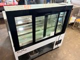 a refrigerated display case in the middle of a room