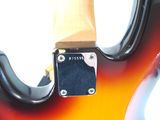 a close up of an electric guitar with a wooden neck