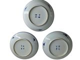 three blue and white plates with blue designs on them on a white surface