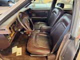 a brown car with leather seats in the back of it