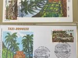 two stamps on a table with a picture of a house and palm trees