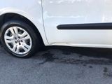 a small white car parked on the side of the road